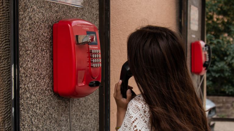 woman using payphone