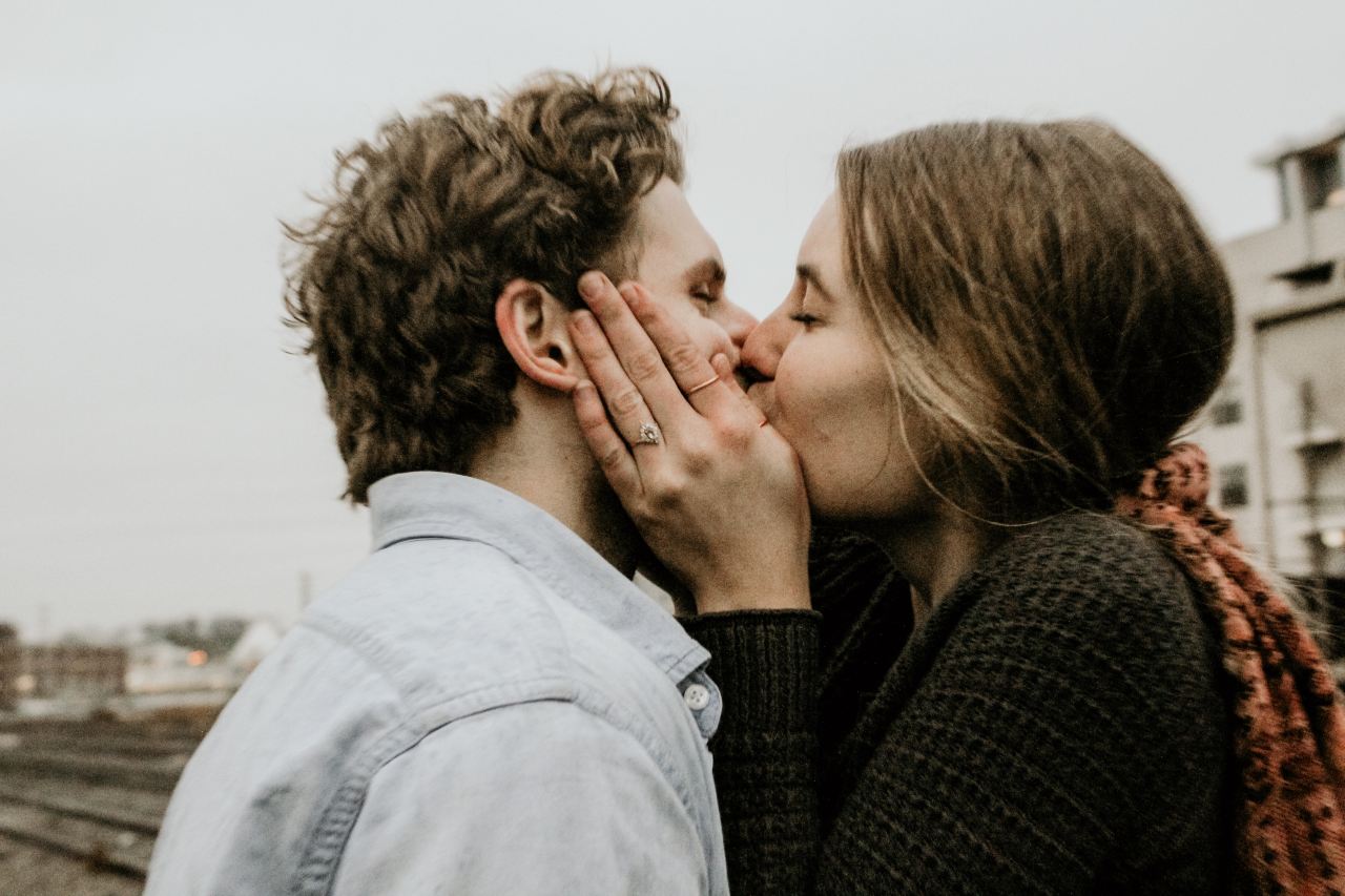 couple kissing under gray clouds