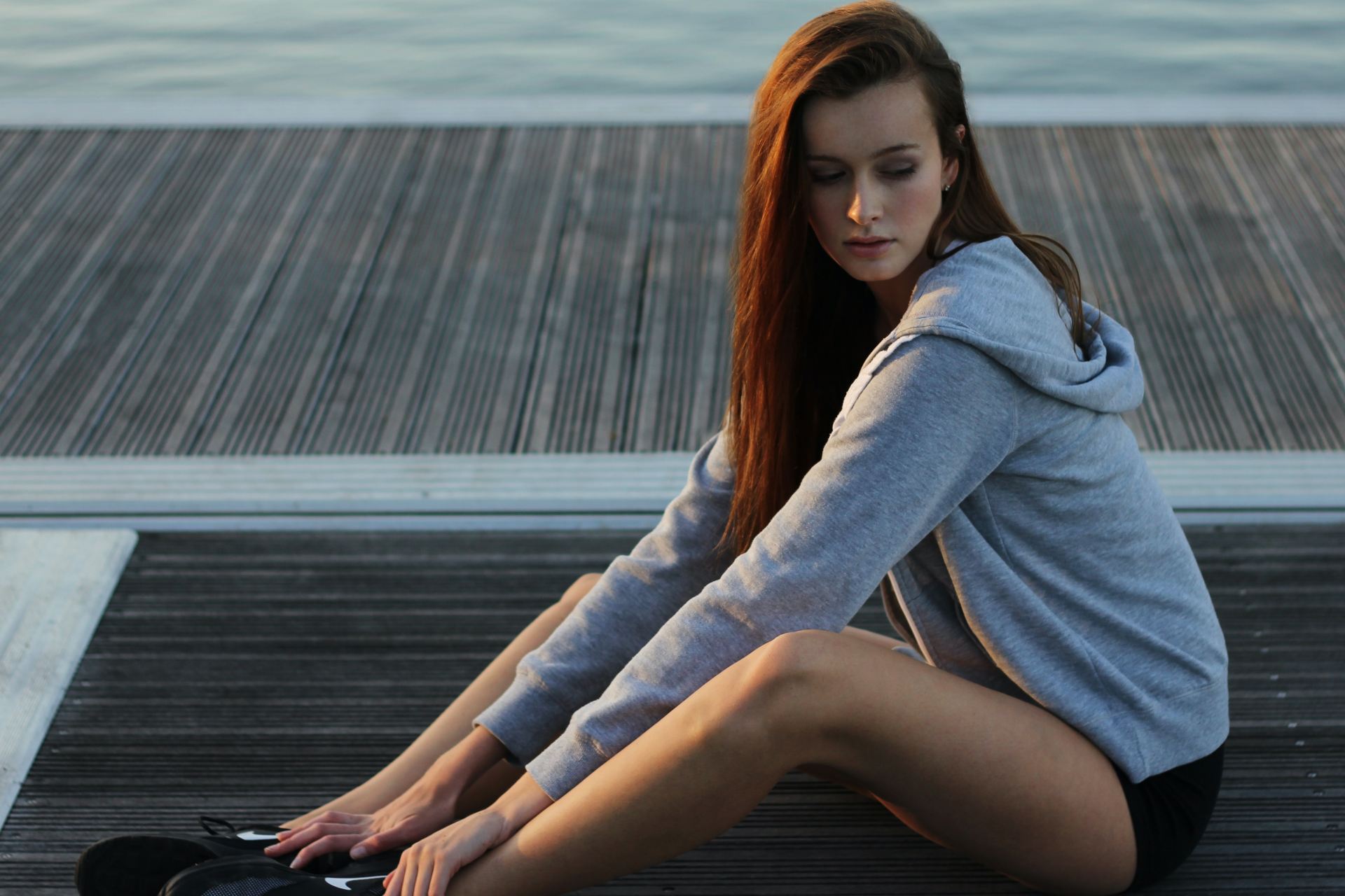 women's gray hoodie doing yoga