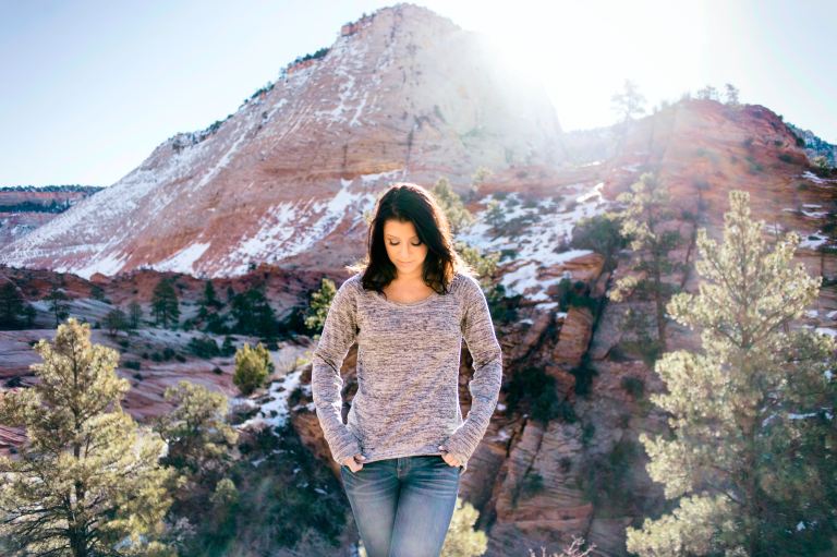 woman standing near tree and alp mountain