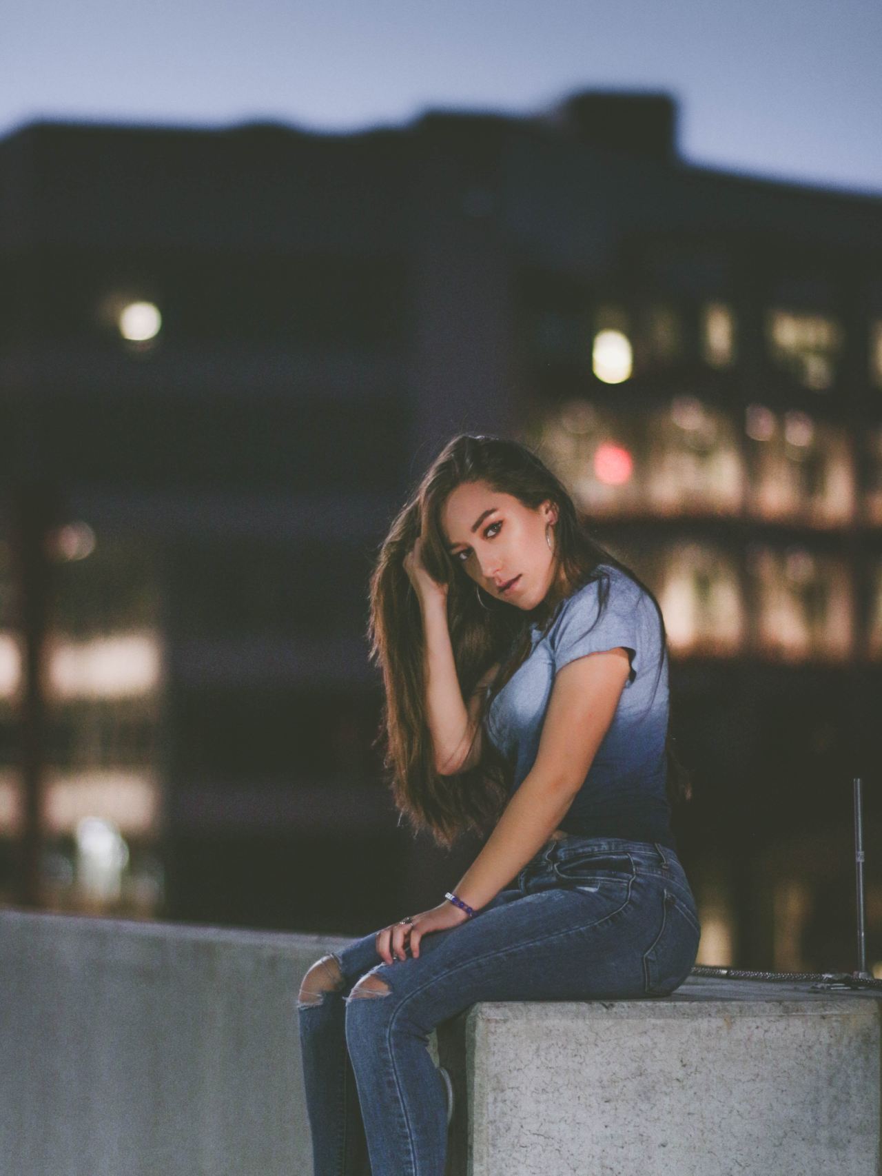 woman sitting on concrete block