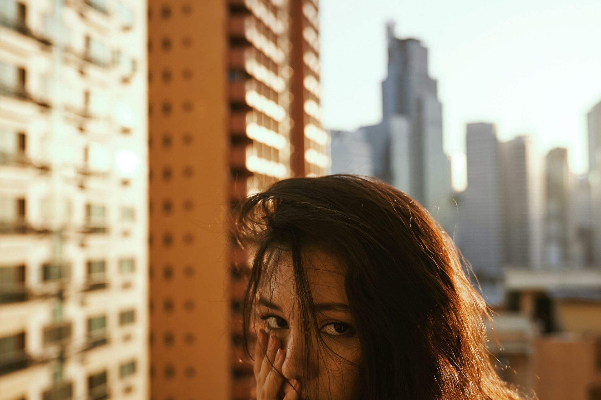 woman in gray top beside building