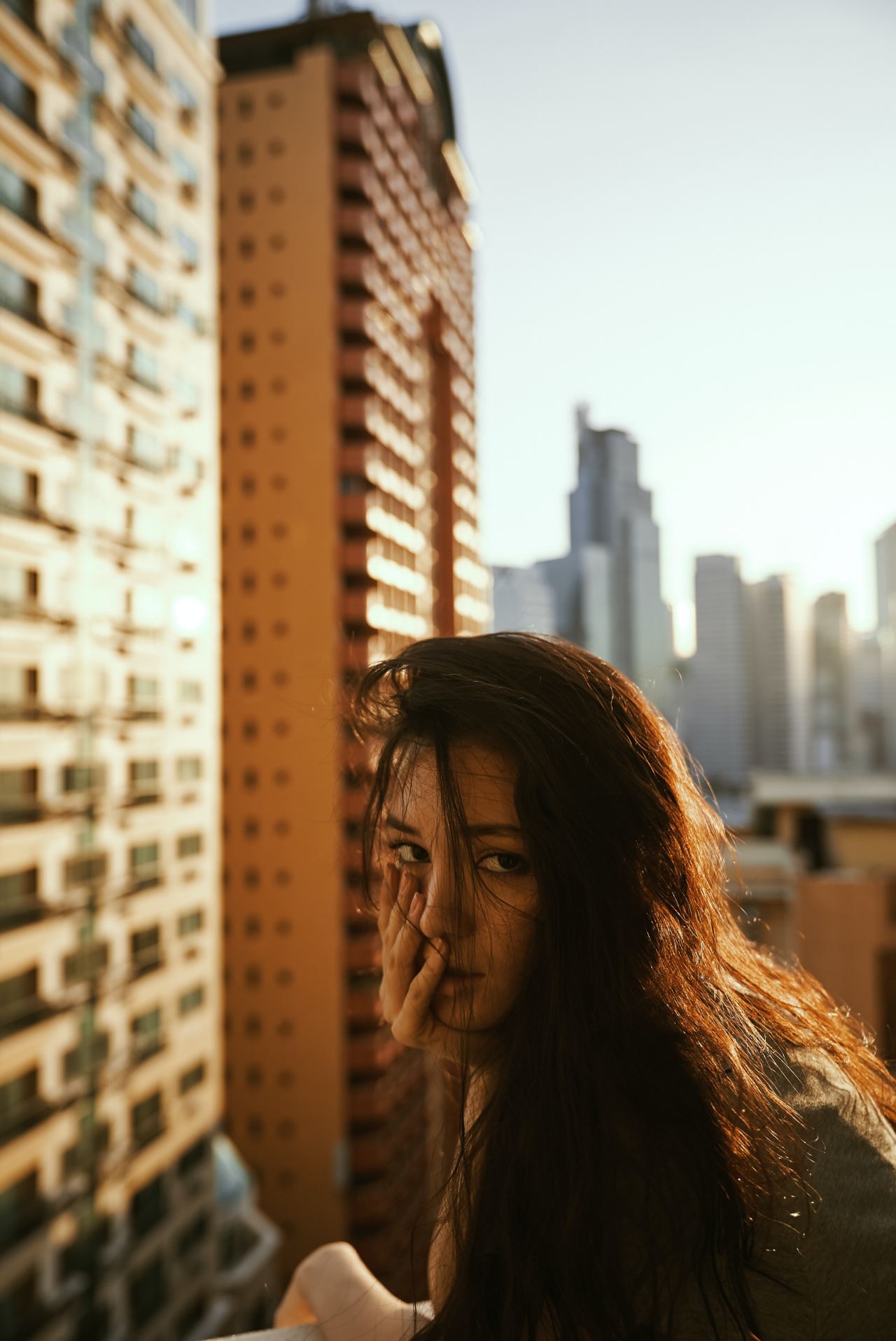 woman in gray top beside building