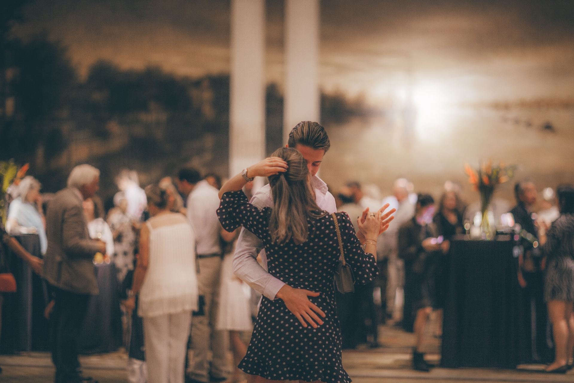 woman in polka-dot dress dancing with man in white dress shirt