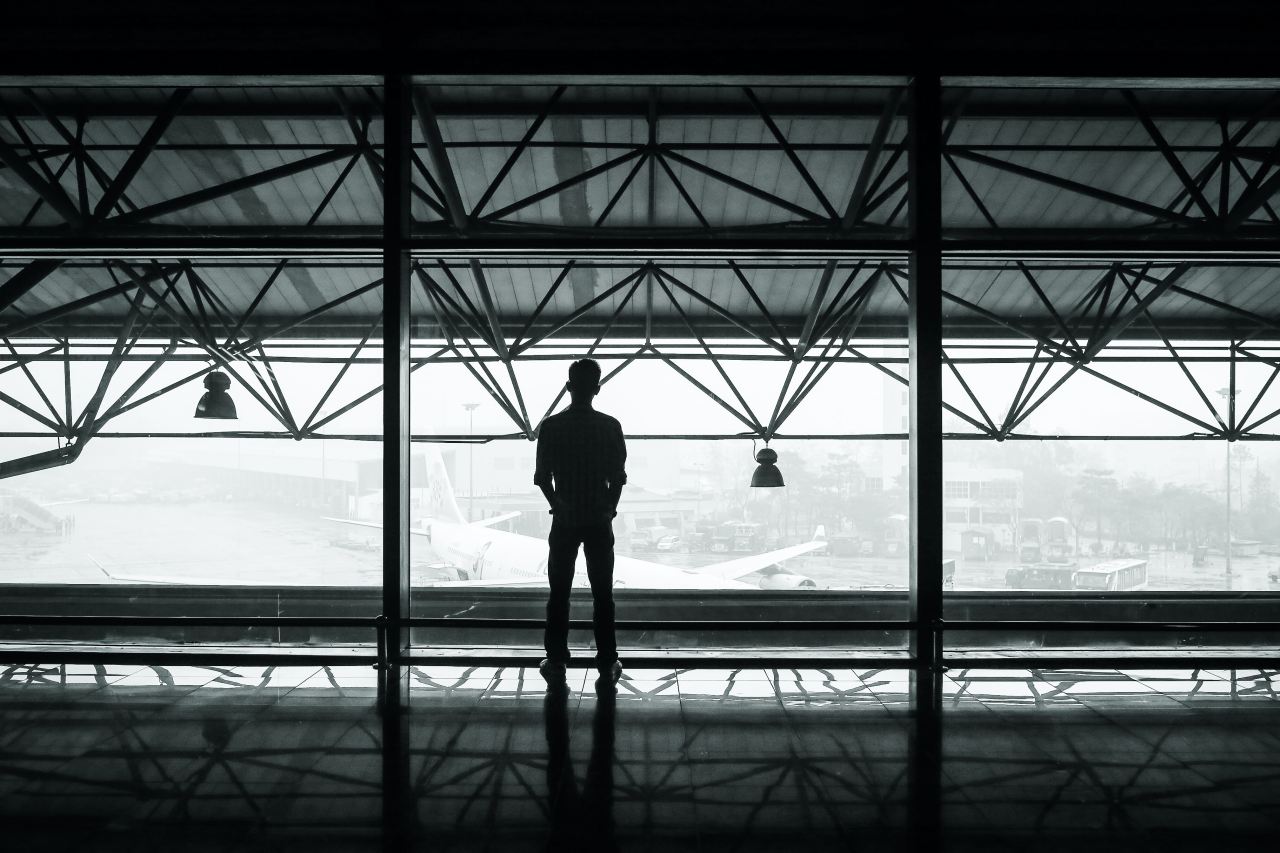 silhouette of man standing between two posts