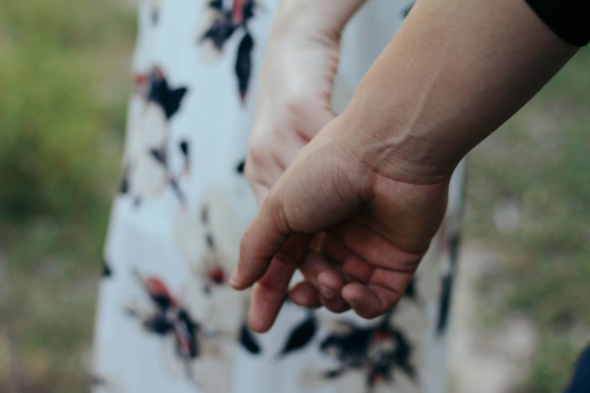 man and woman holding hands