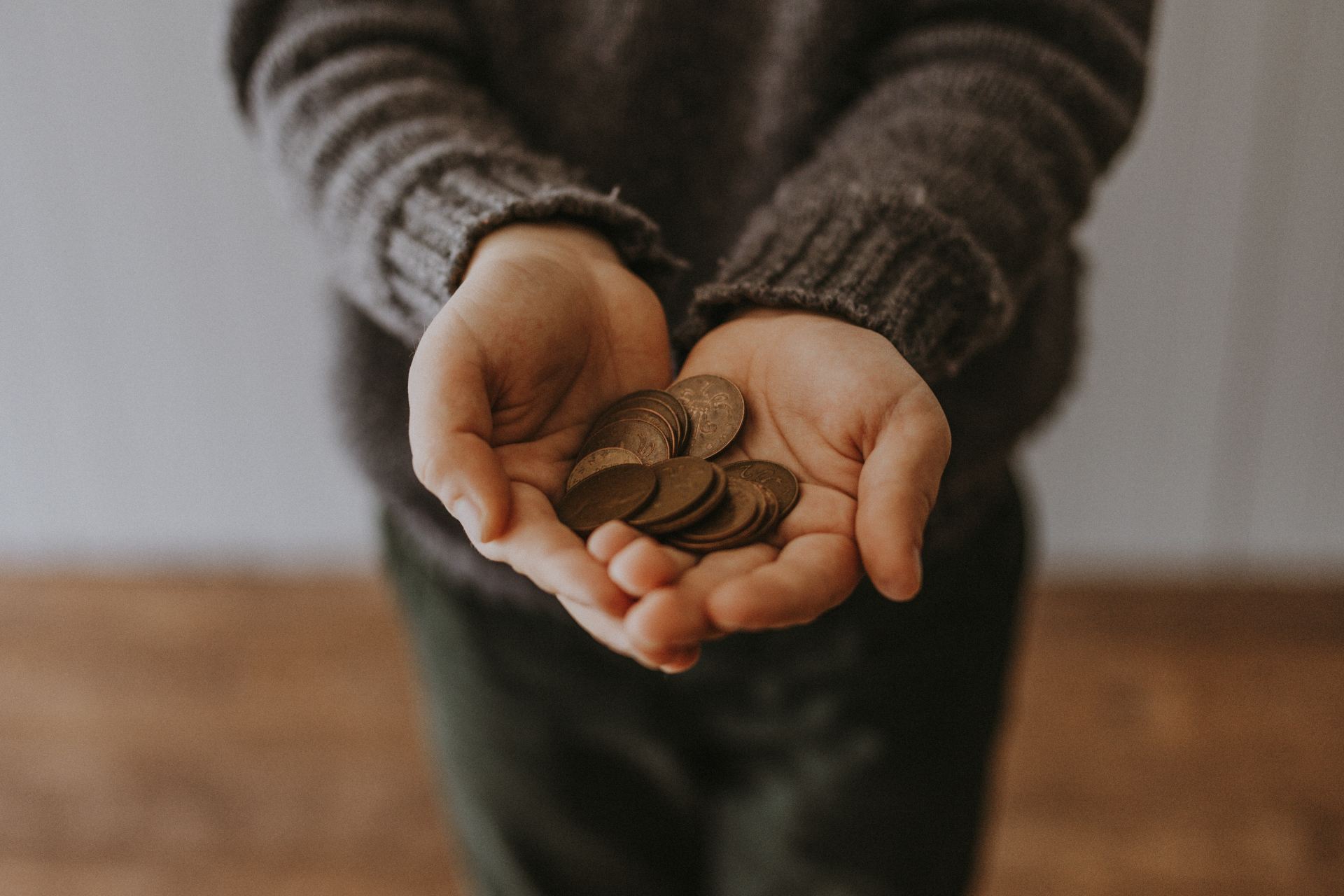 copper-colored coins on in person's hands