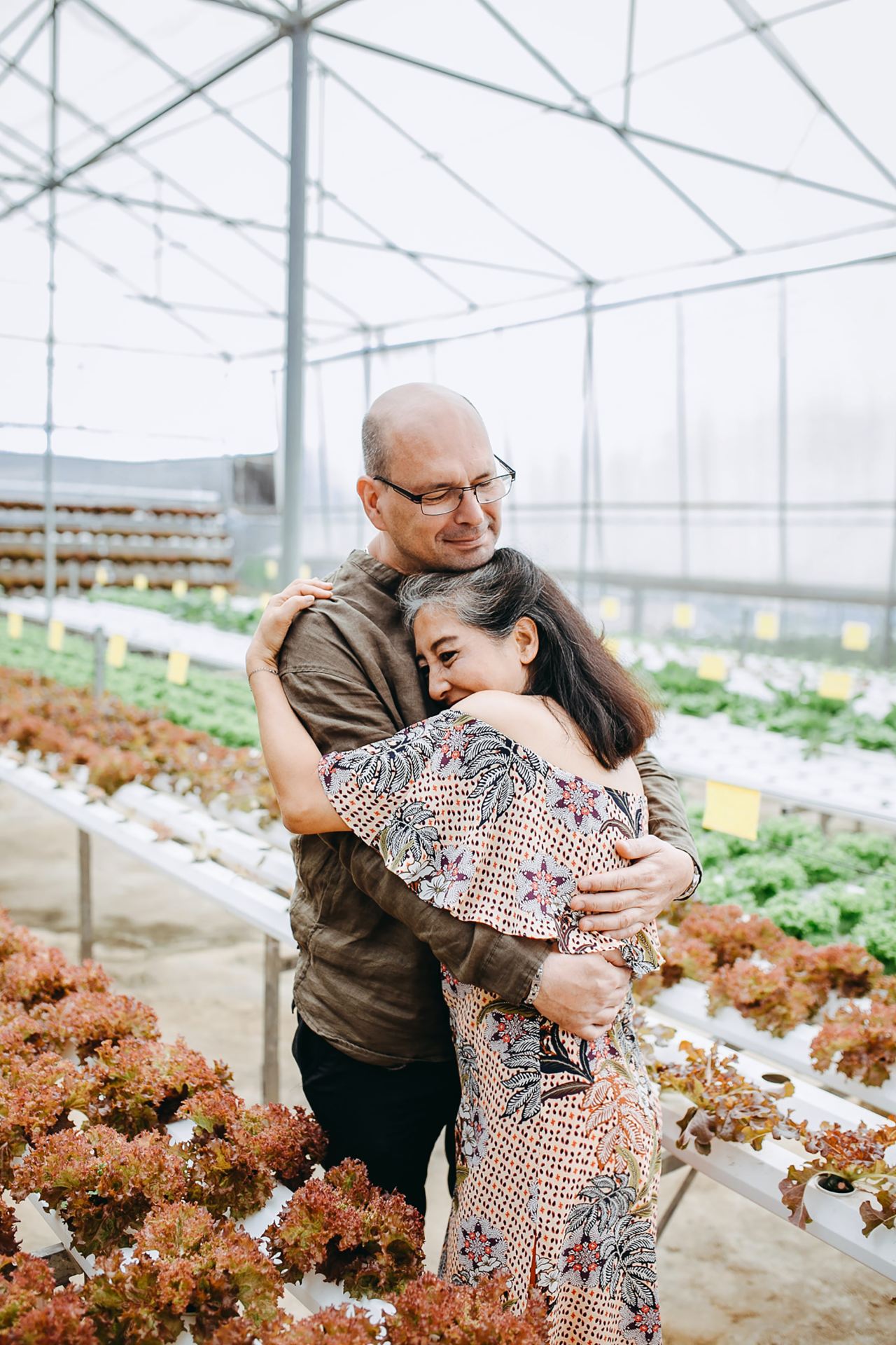 man hugging woman inside garden house