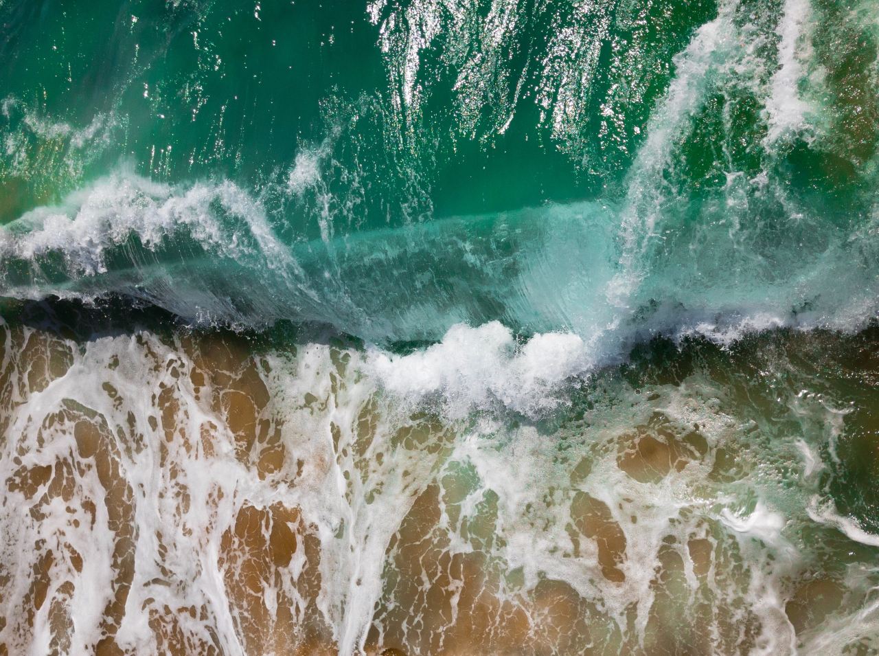 aerial photography of sea waves on seashore during daytime