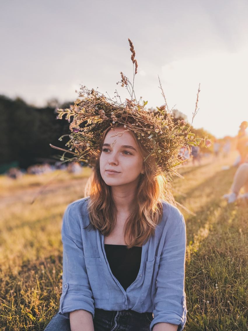 woman sitting down on grass