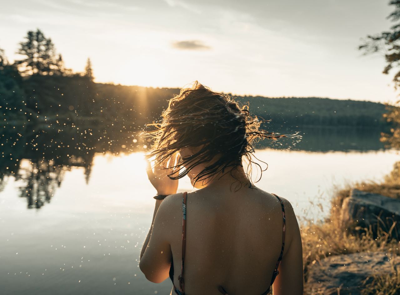 woman in black bikini top standing on water during daytime