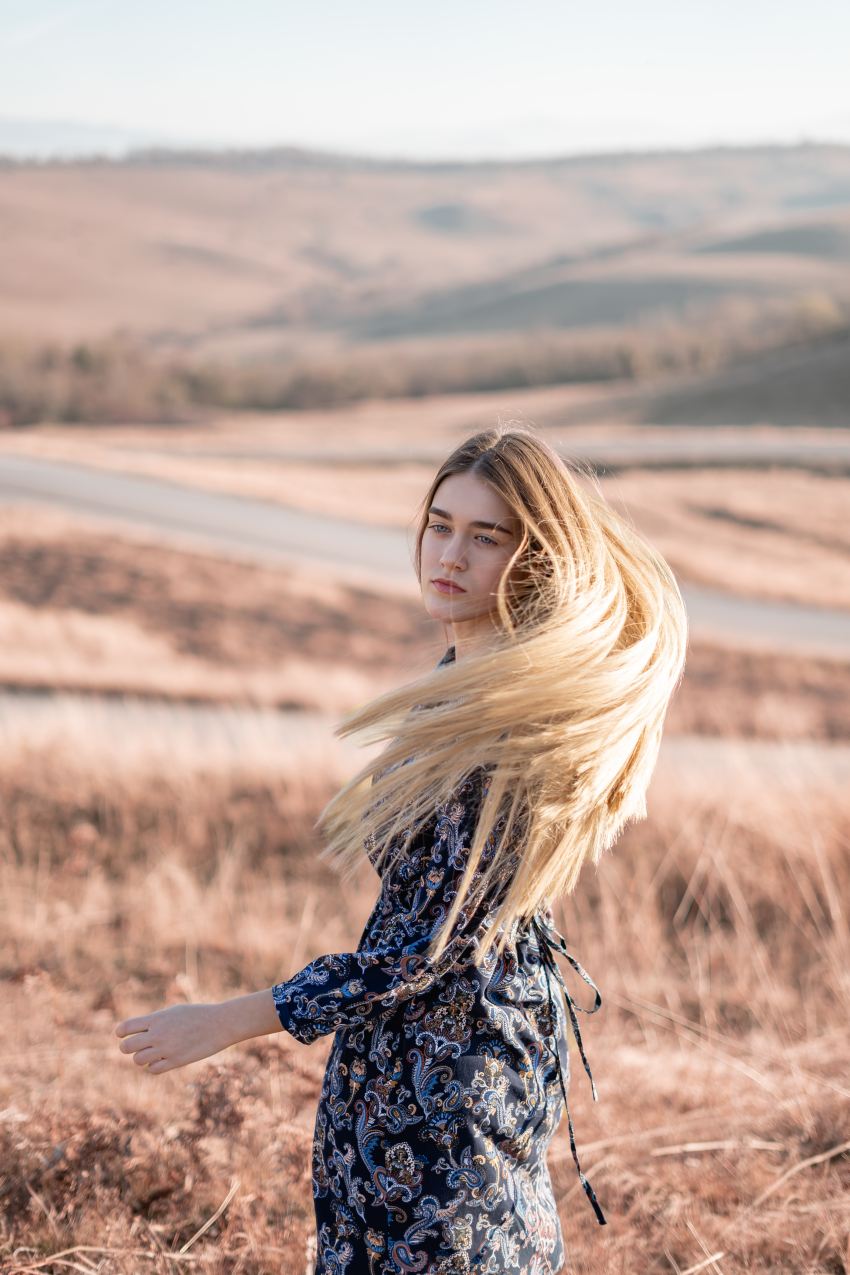 woman standing in brown field