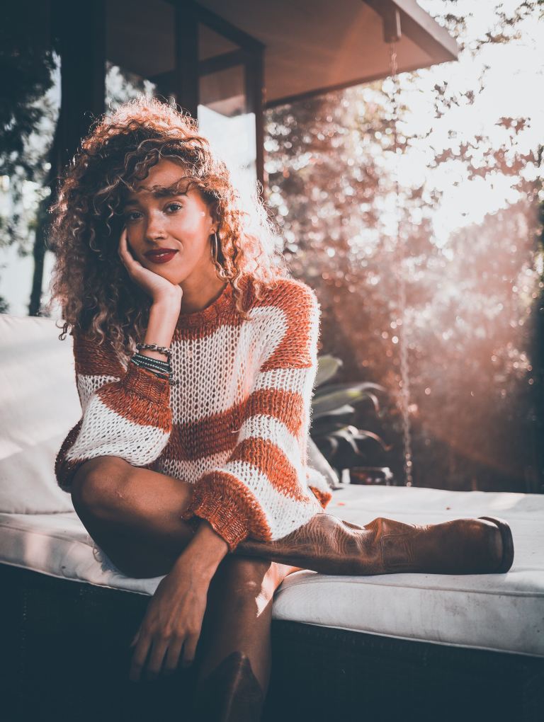 woman wearing brown and white long-sleeved shirt