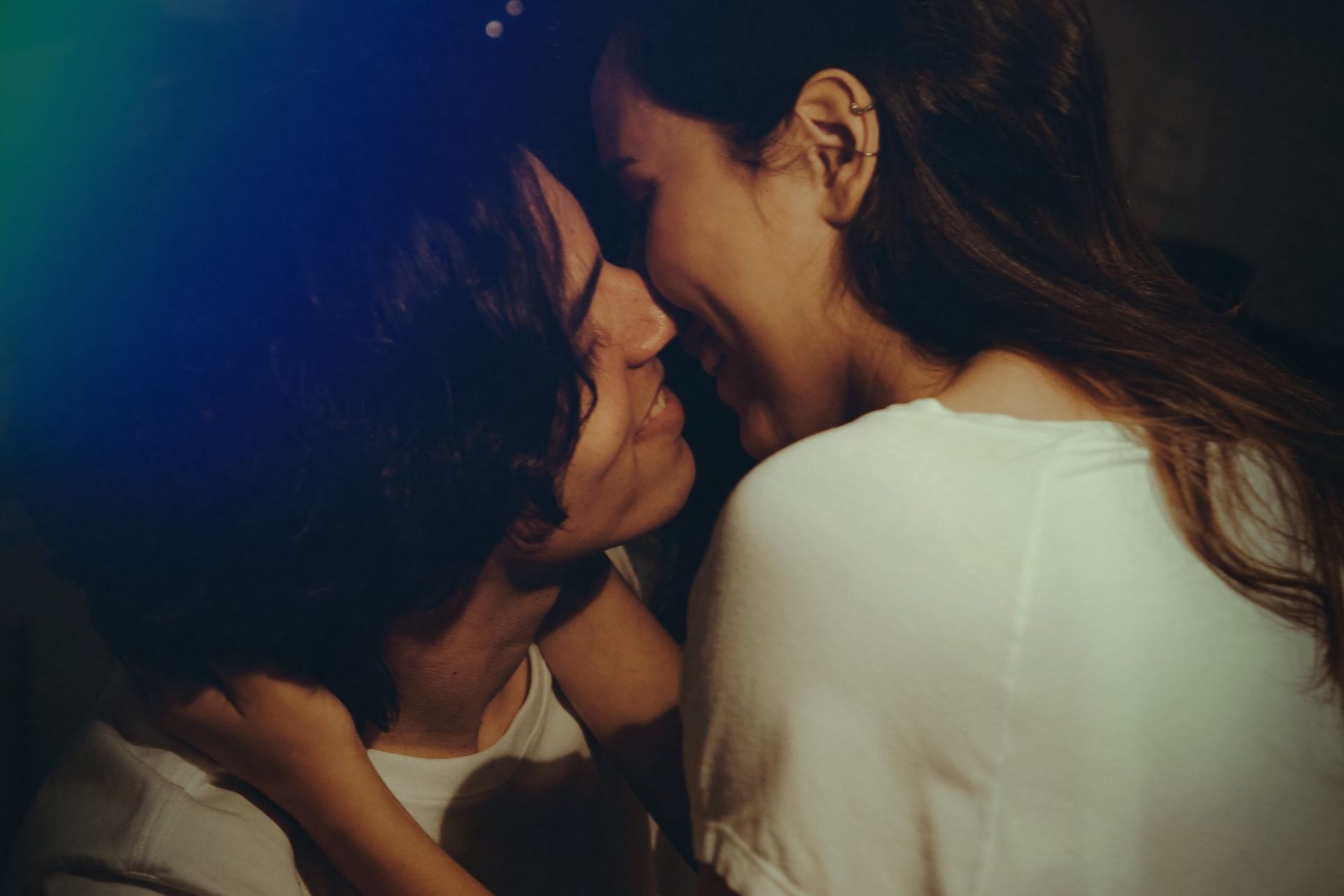 man and woman wearing white top kissing