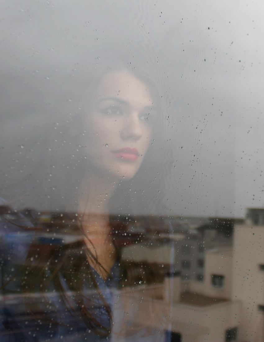 woman looking through window