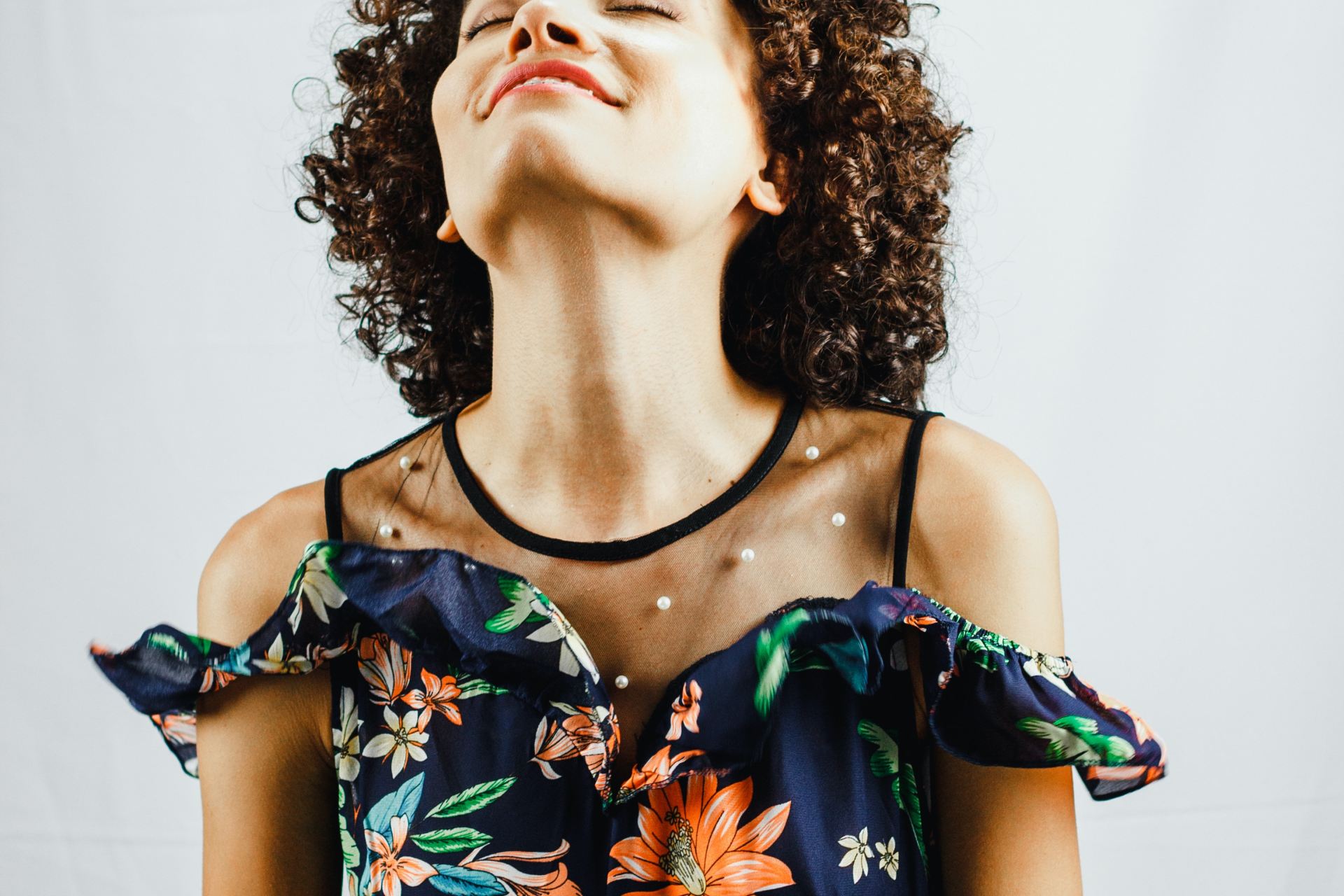 woman smiling while looking upwards