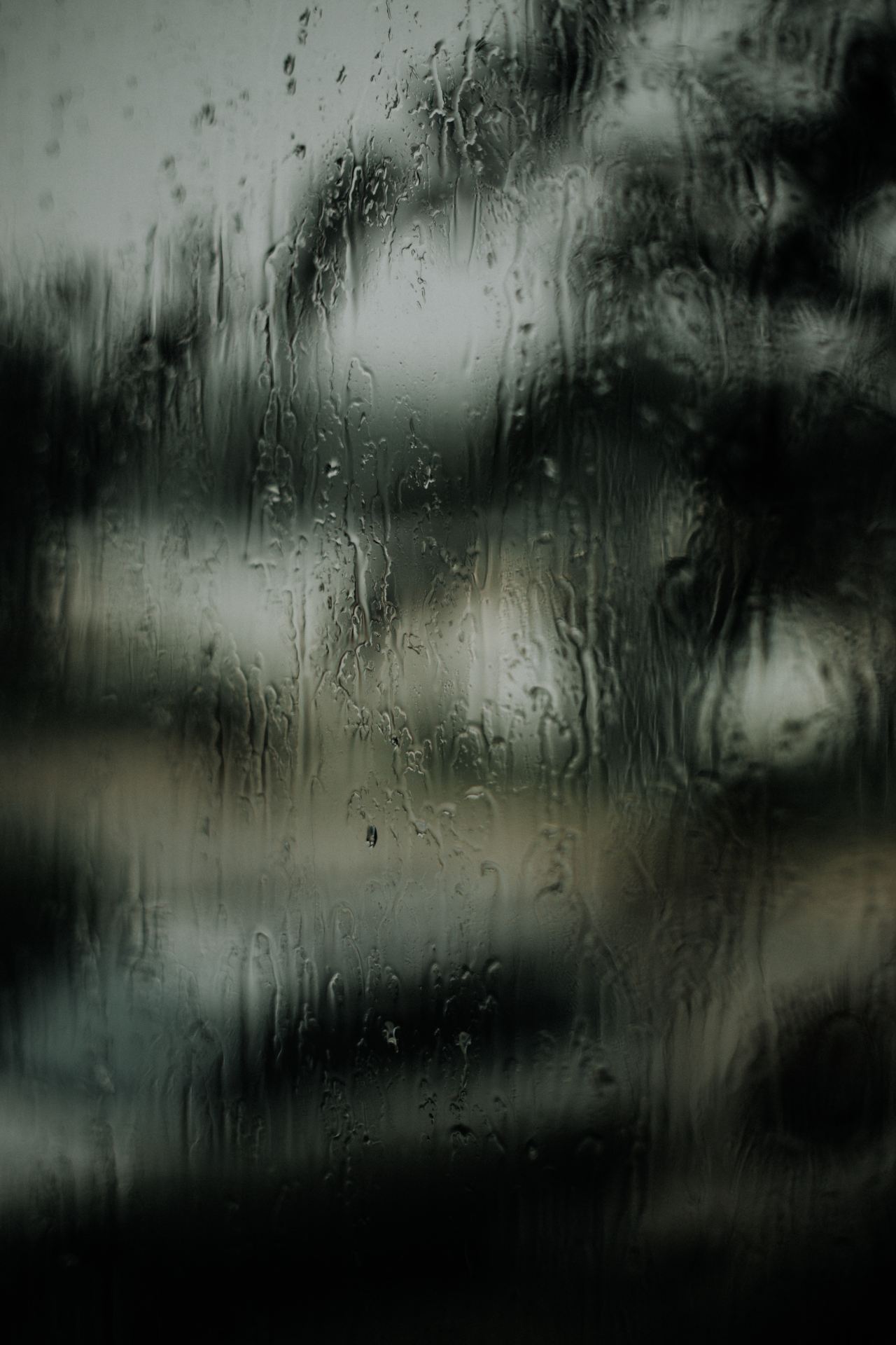 macro photography of water droplets on clear glass