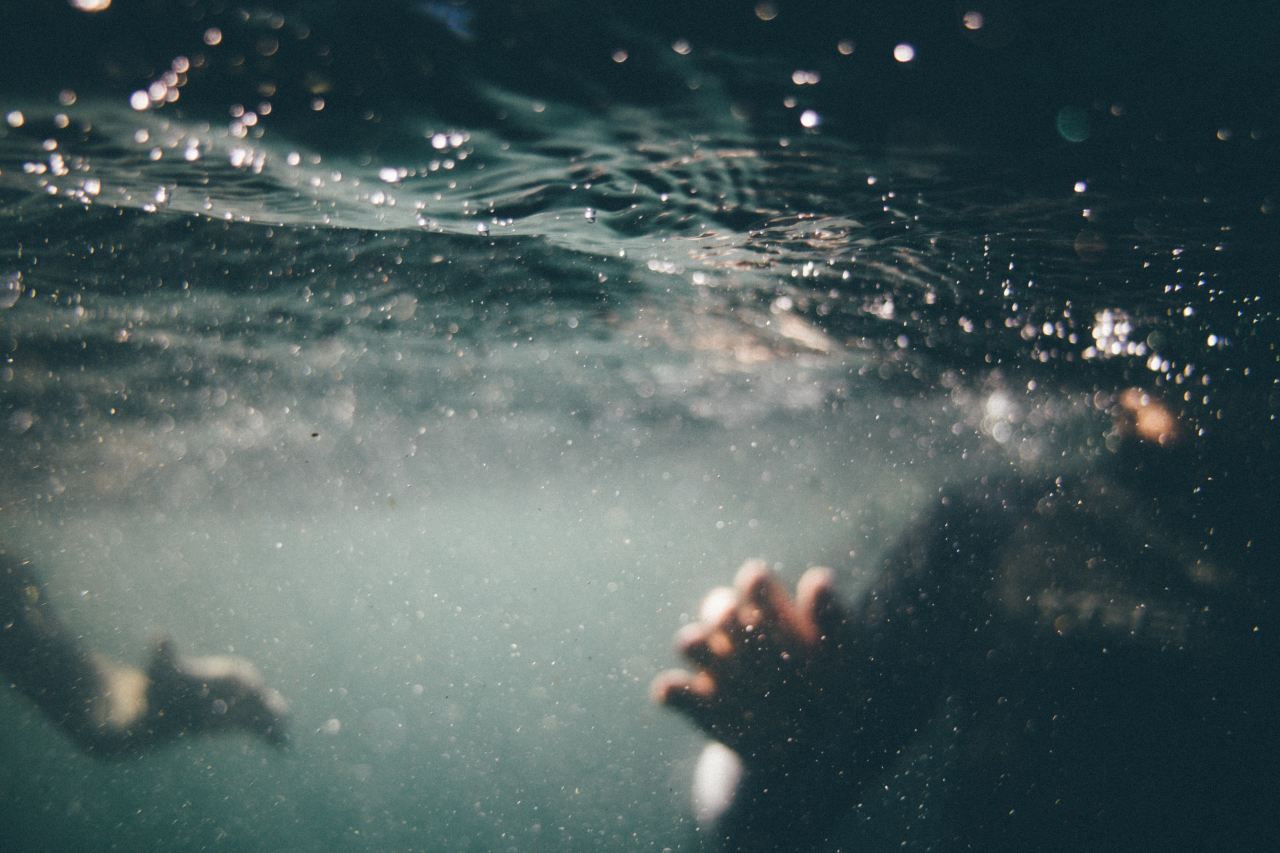 underwater photo of person wearing black shirt