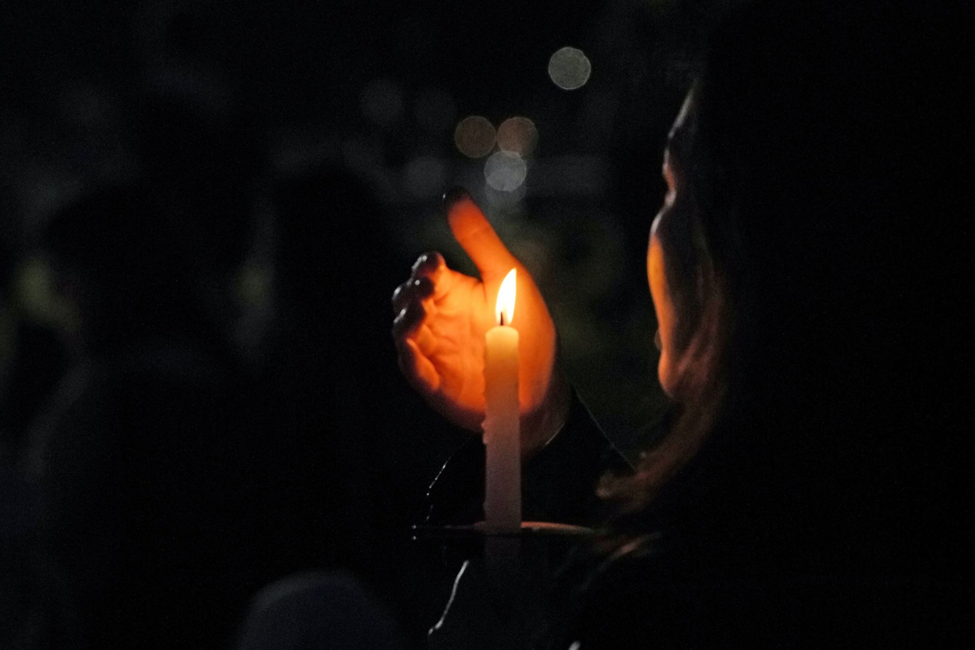 woman holding lit candle