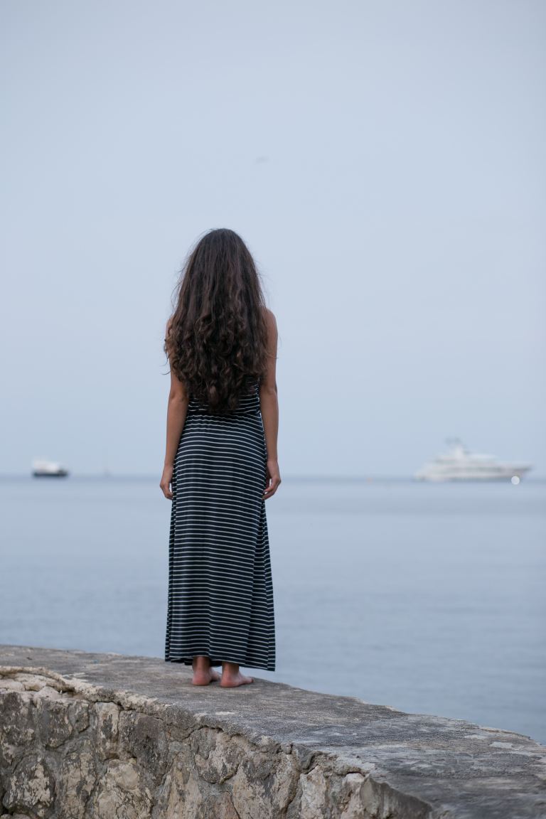 woman standing on gray pavement