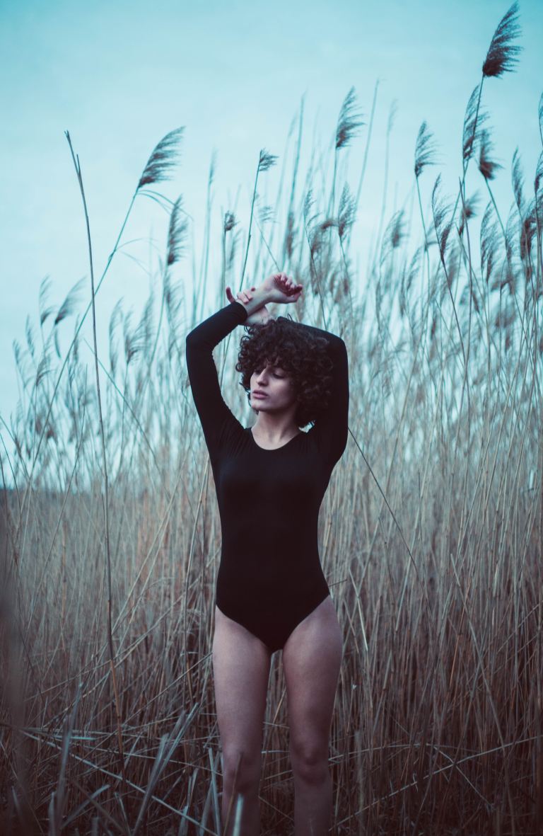 woman standing near grass field