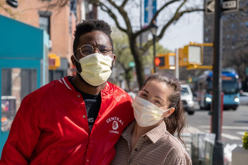 man in red jacket wearing white mask