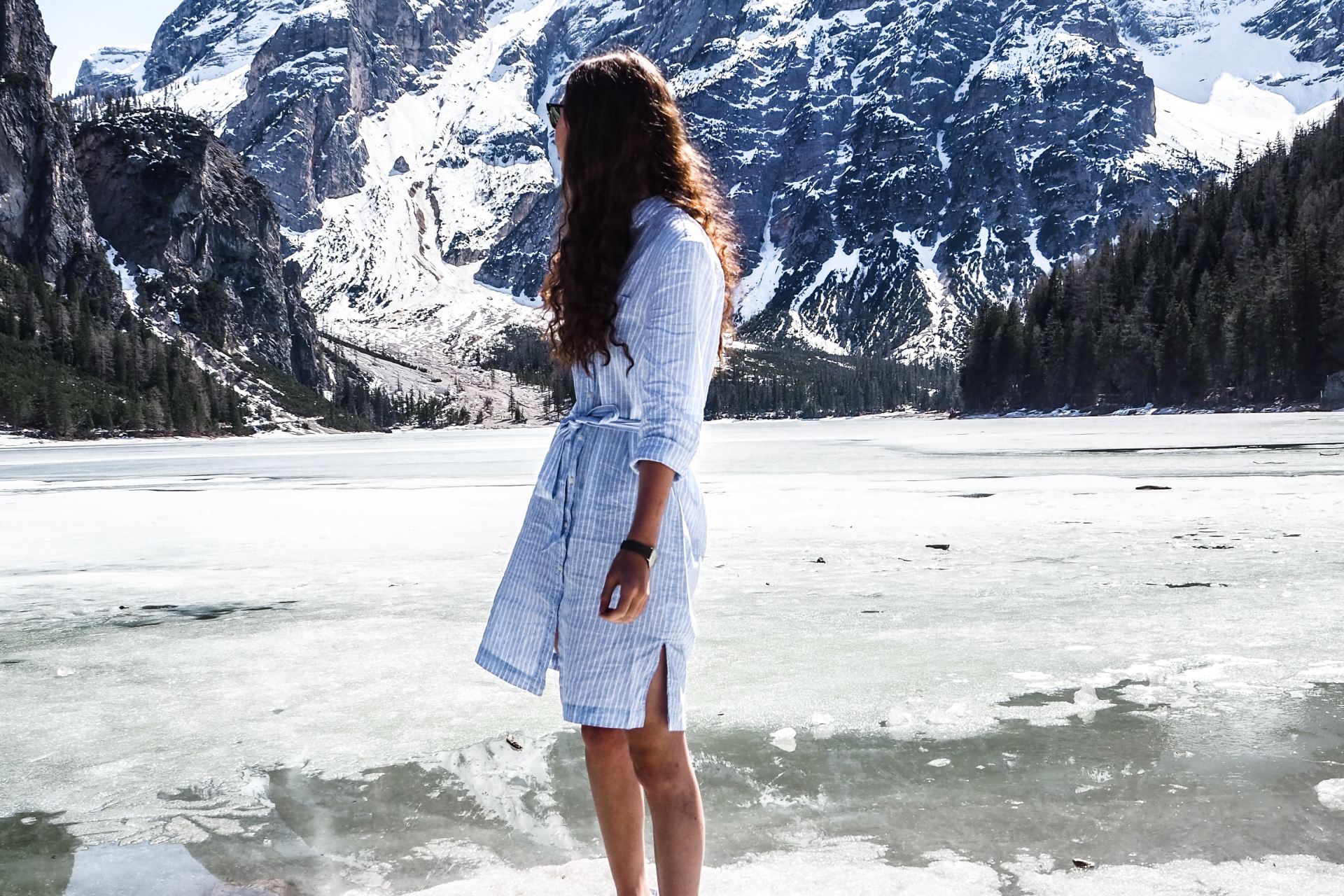 woman standing near snow covered field during daytime