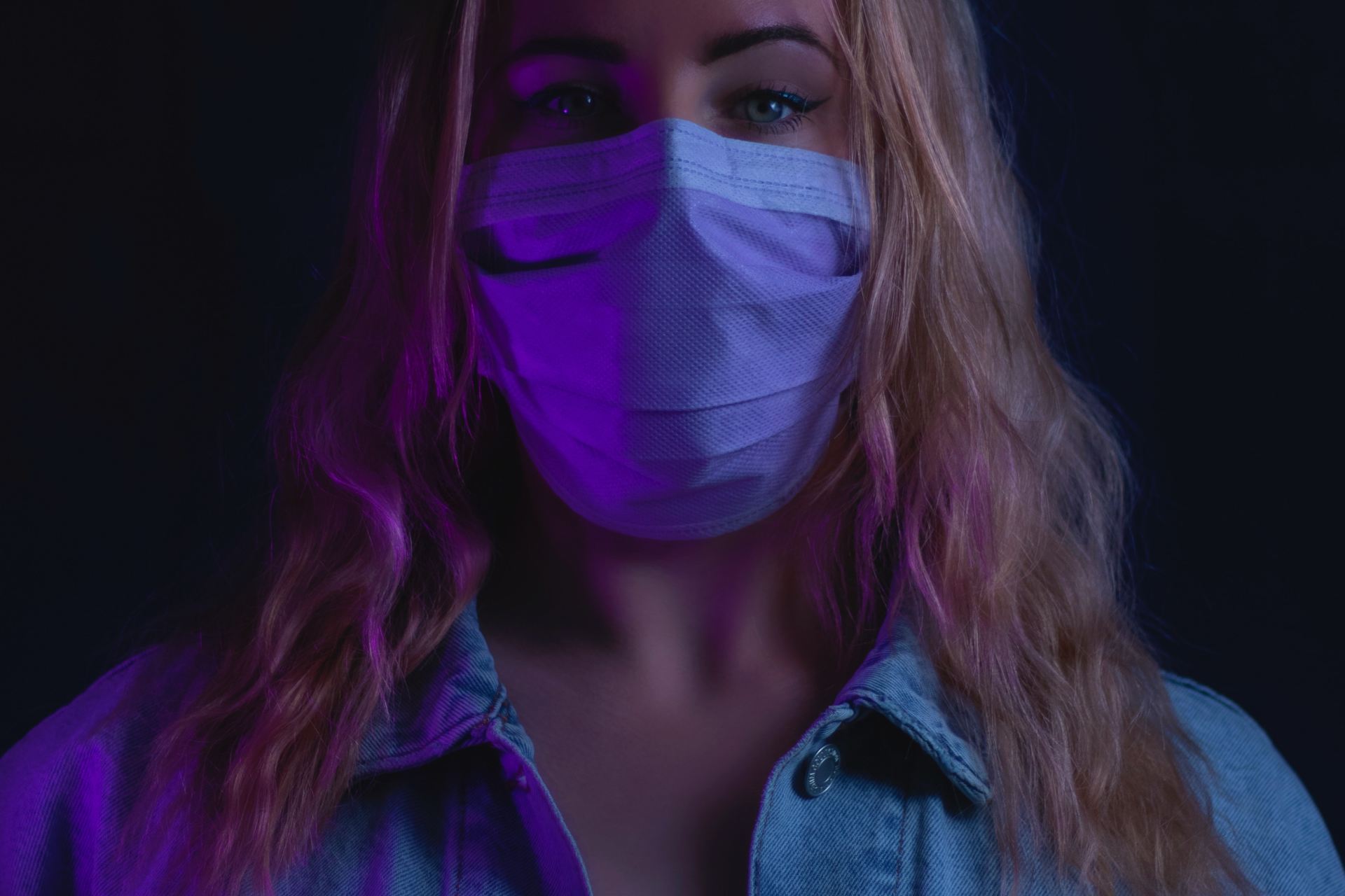 woman in purple denim jacket with white mask