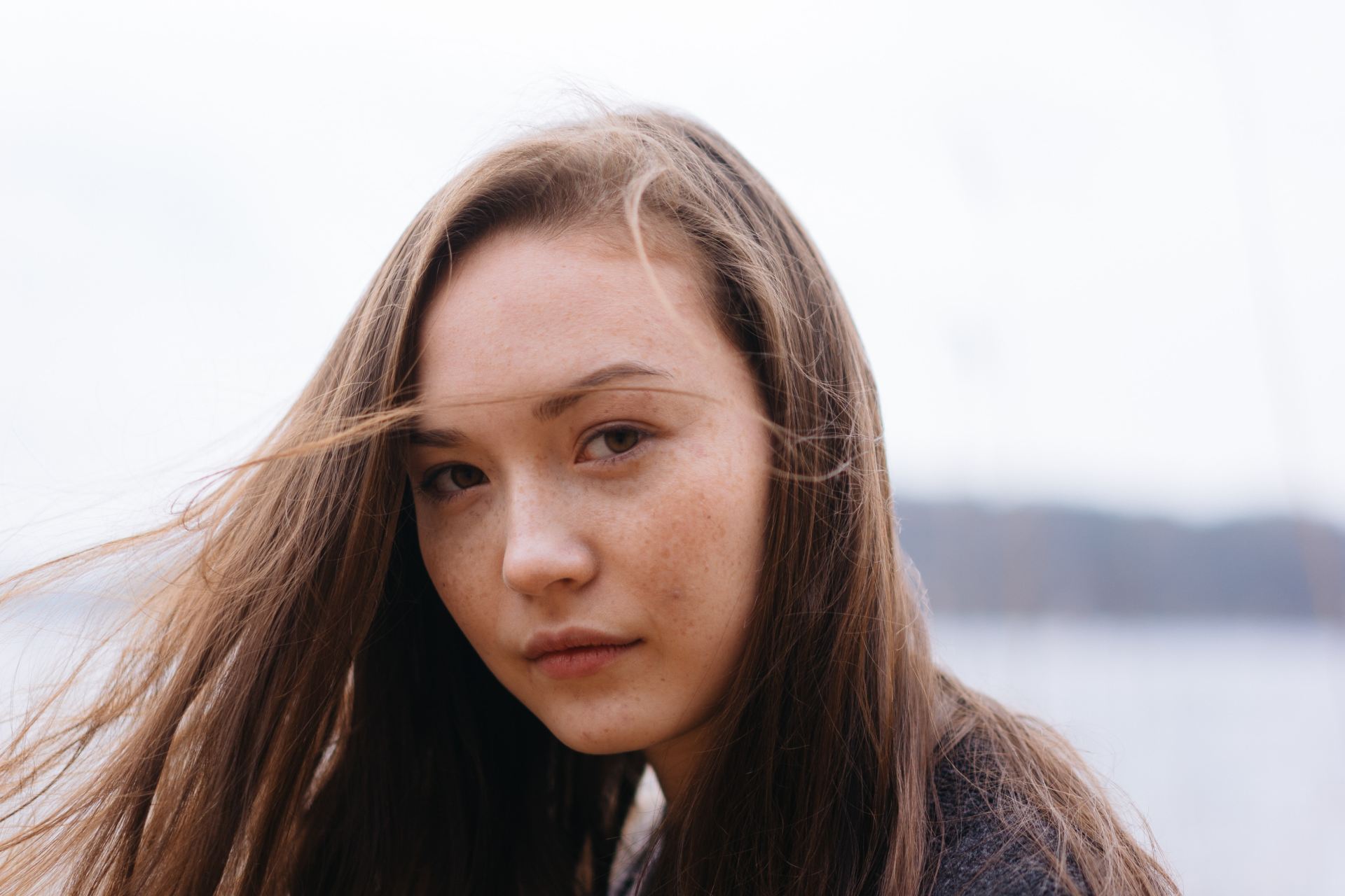 woman in black sweater on shore during daytime