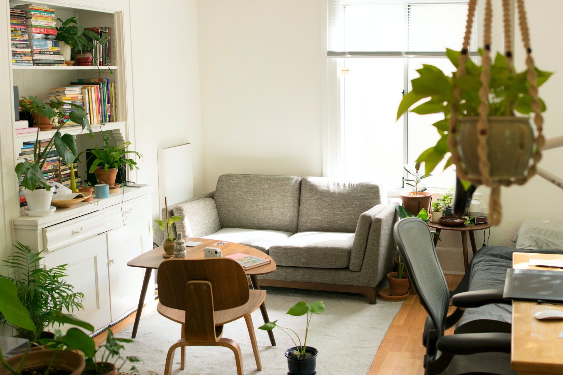 gray fabric loveseat near brown wooden table