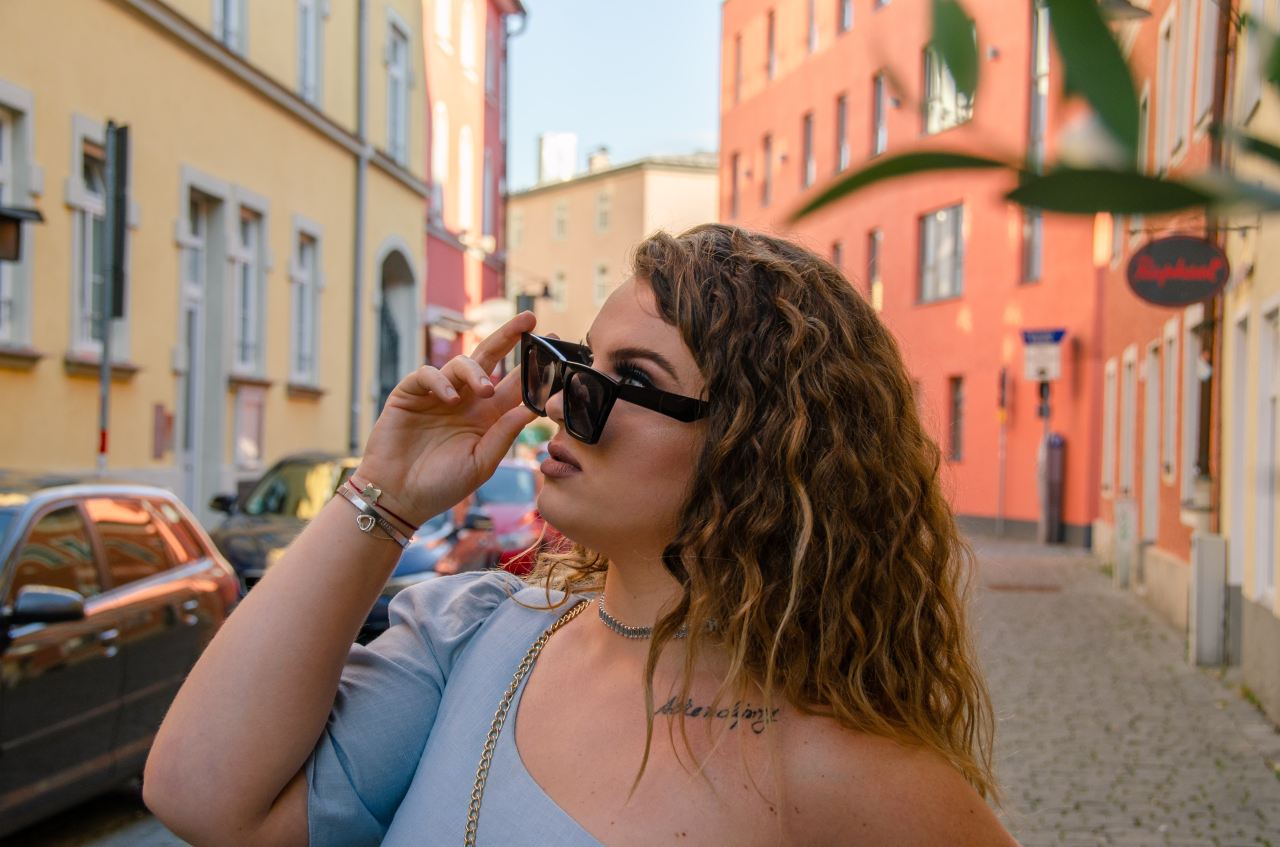 woman in white tank top wearing black sunglasses