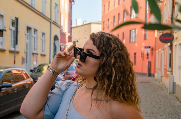 woman in white tank top wearing black sunglasses