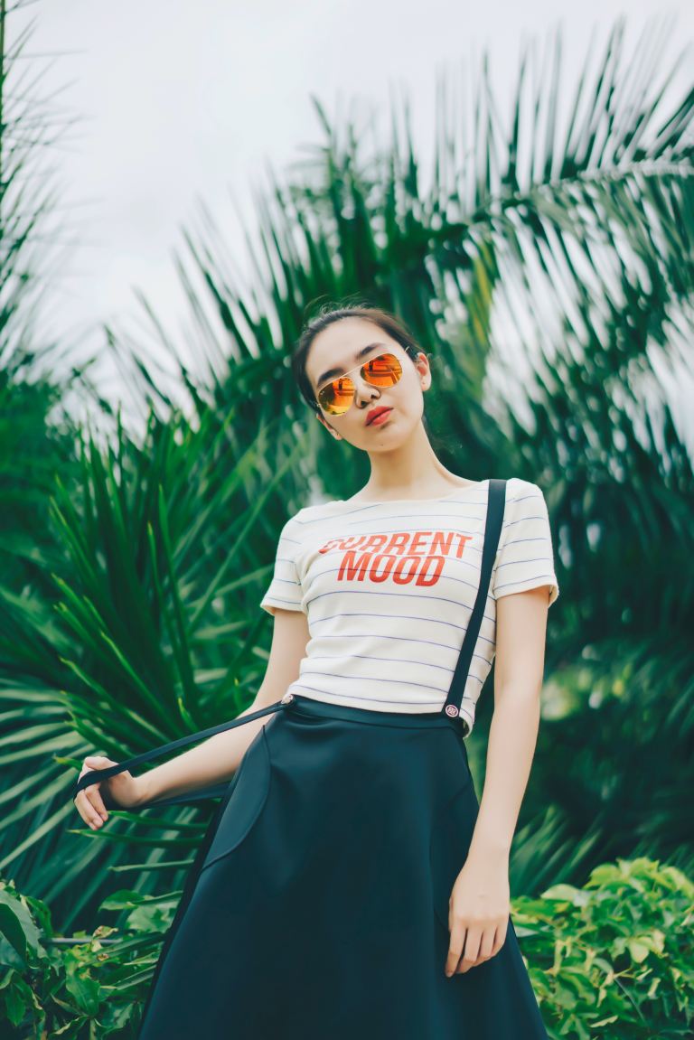 woman standing near green plant