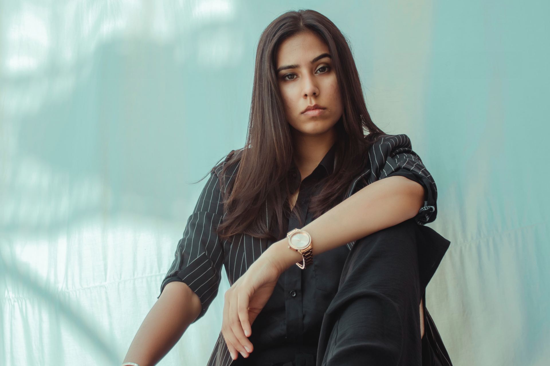 woman in black dress sitting on floor