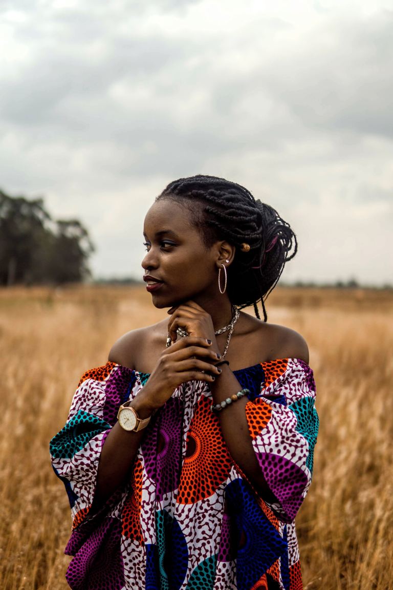 woman standing on brown grass