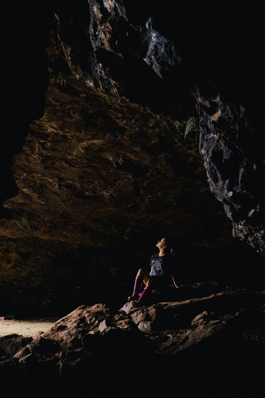 woman sitting inside cave