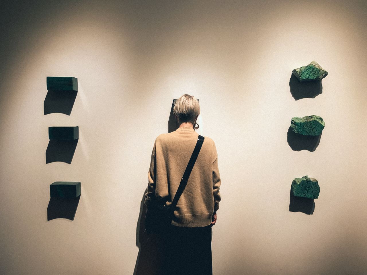 person standing in front of white wall