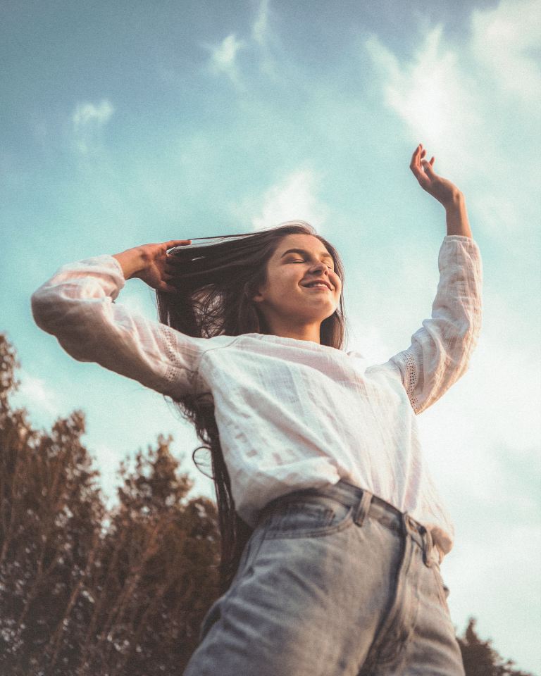 woman in white long sleeve shirt and blue denim jeans