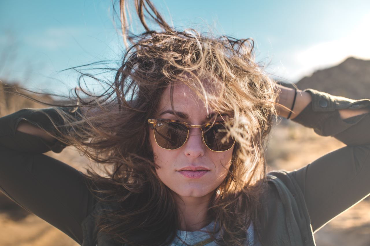 closeup photo of woman holding her hair