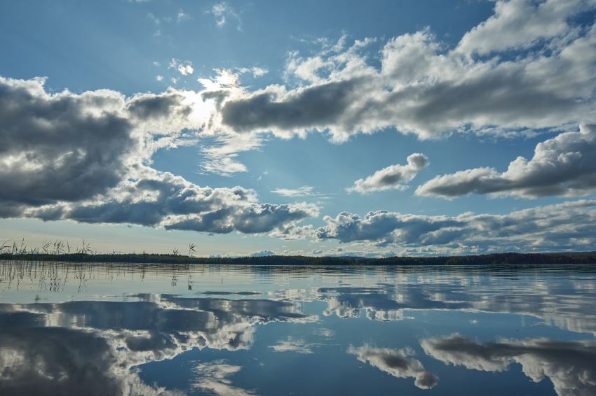 blue sky and white clouds over lake