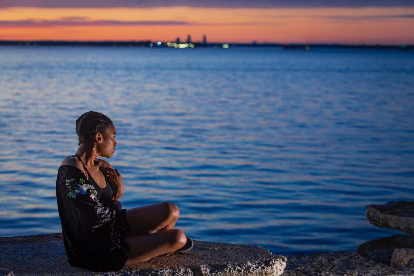 woman sitting near sea