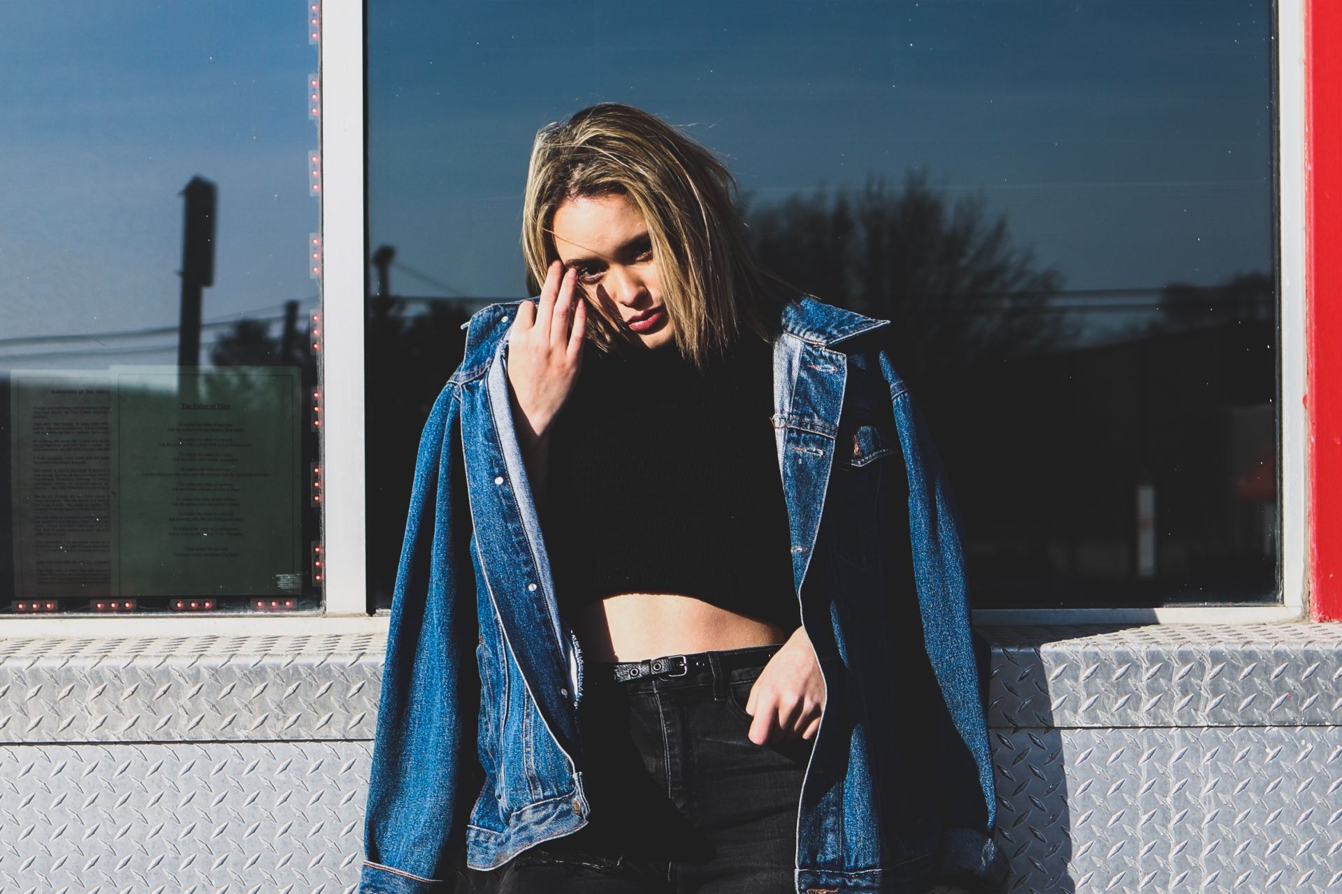 woman leaning on stainless steel bench