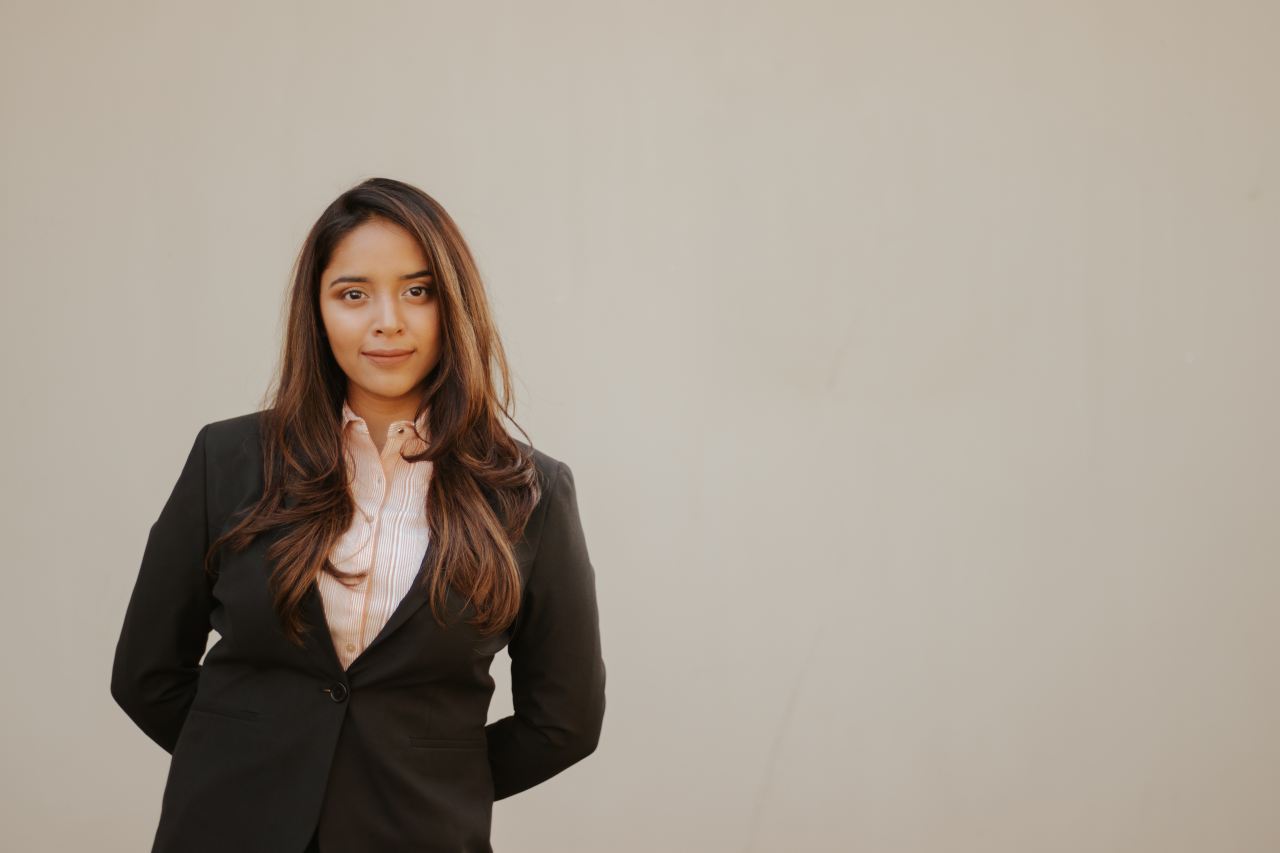 woman in black blazer smiling