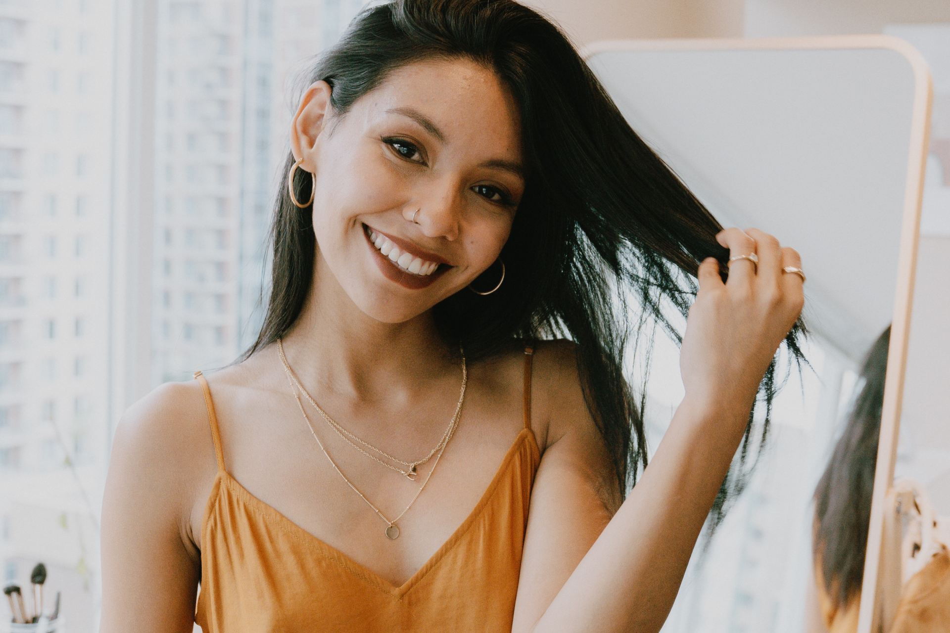 woman in yellow tank top smiling