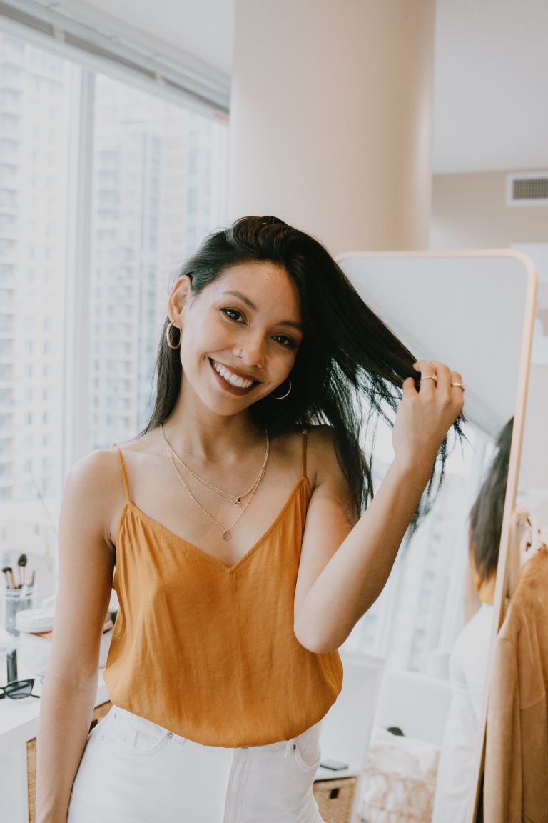 woman in yellow tank top smiling