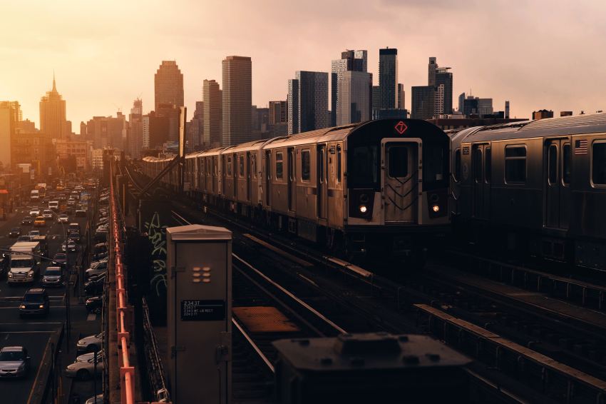 train approaching near high-rise buildings