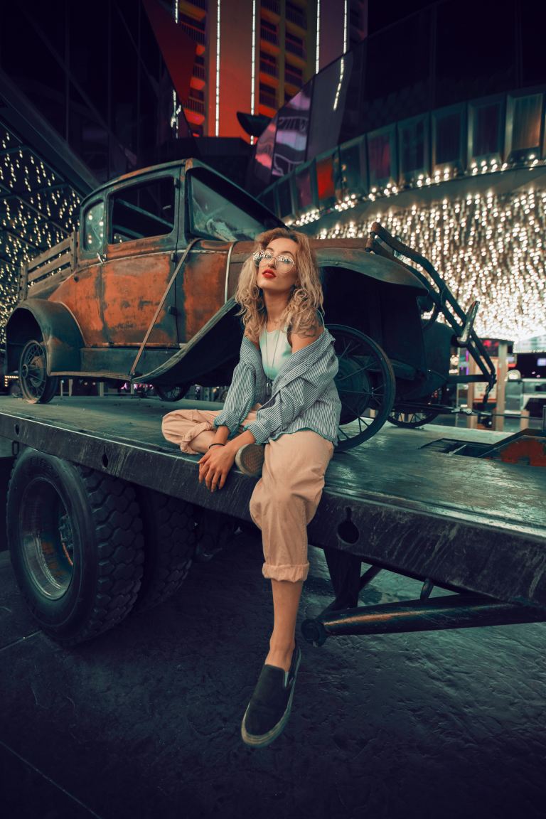 woman sitting on utility trailer during night