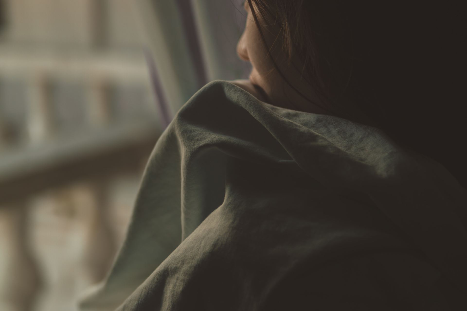 woman in black shirt looking at window