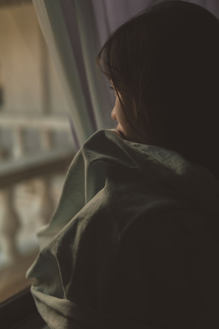 woman in black shirt looking at window