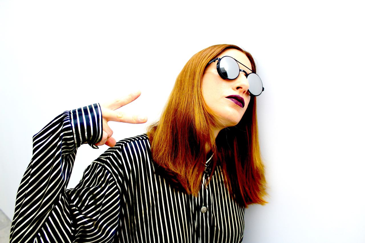 woman in black and white striped long sleeve shirt wearing black sunglasses